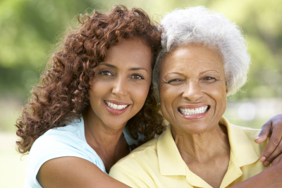 caregiver and senior woman smiling