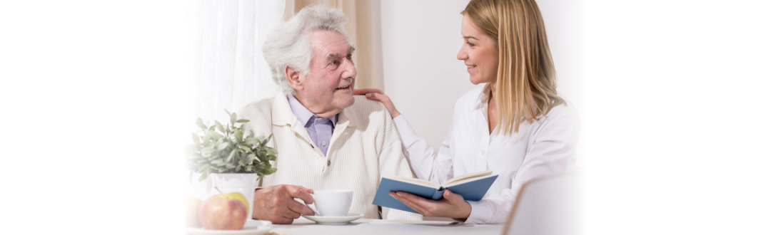 old man and his caregiver talking