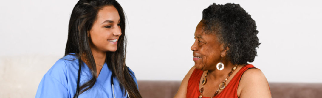 caregiver and old woman staring at each other